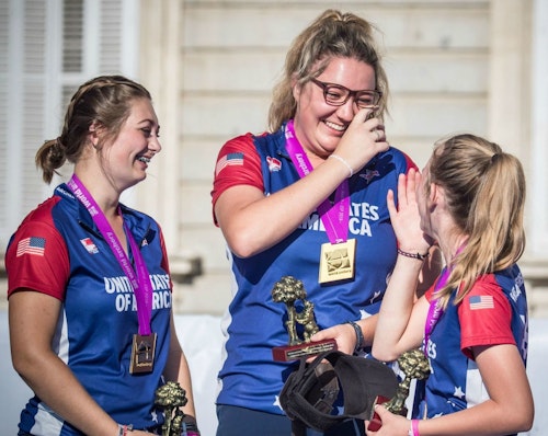 Faith Miller (center) celebrates with her Team USA compound cadet women’s teammates.