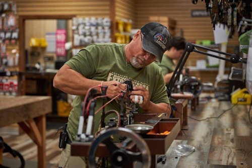Jeff Haas repairs a bow at Lancaster Archery Supply’s Bowhunter's Extravaganza event. The 2-day event offers big sales, an outdoor film festival and even an auction.