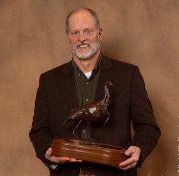 Toxey Haas holding the Lynn Boykin Hunting Heritage Award.
