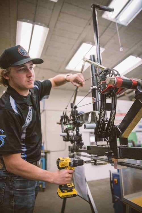 The behind-the-scenes factory pics shown in this article came from Prime Archery. In the photo above, Marketing Manager Casey VanDerGraaf is shown assembling a new flagship compound.