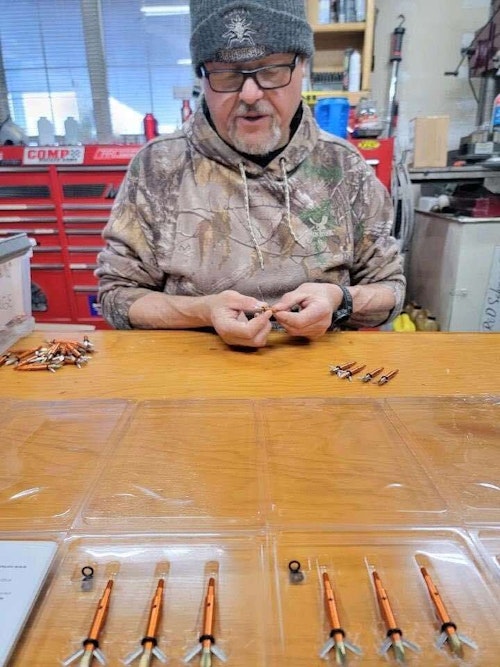 Rodney Ward inspecting broadheads before weighing them.  This is part of the company’s quality control process before packaging.